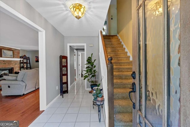 foyer entrance featuring light hardwood / wood-style floors and a fireplace