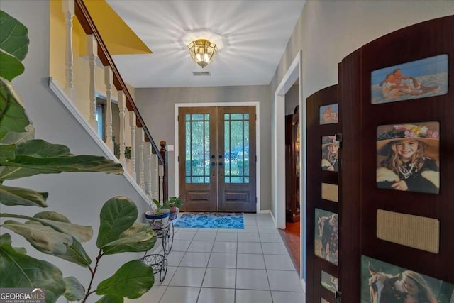 entryway with french doors and light tile patterned floors