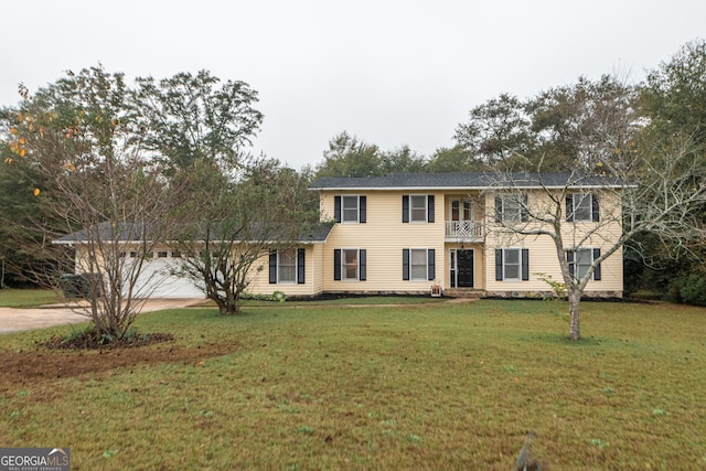 colonial inspired home with a balcony, a front lawn, and a garage