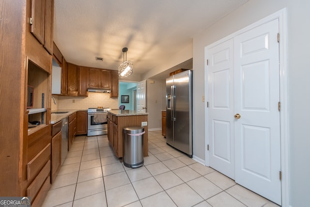 kitchen featuring sink, hanging light fixtures, decorative backsplash, a kitchen island, and stainless steel appliances