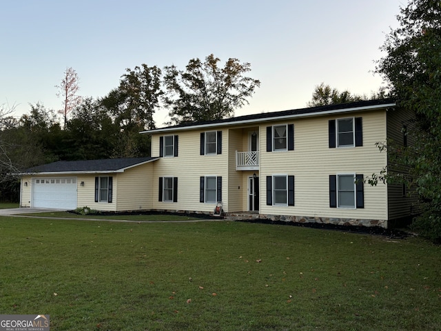 colonial inspired home with a balcony, a front lawn, and a garage