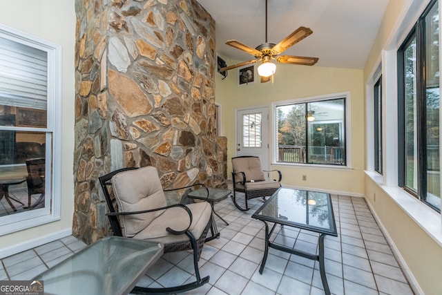 sunroom with ceiling fan and lofted ceiling