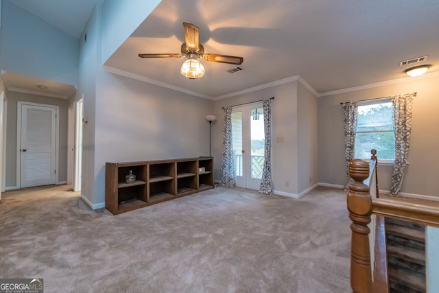 interior space featuring ceiling fan, ornamental molding, light carpet, and vaulted ceiling