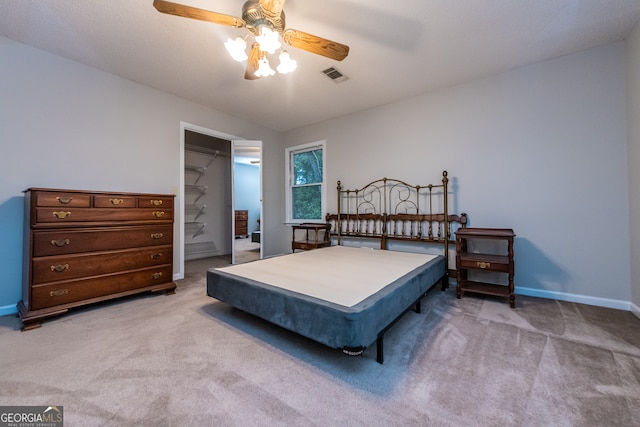 bedroom featuring ceiling fan, a closet, and carpet floors