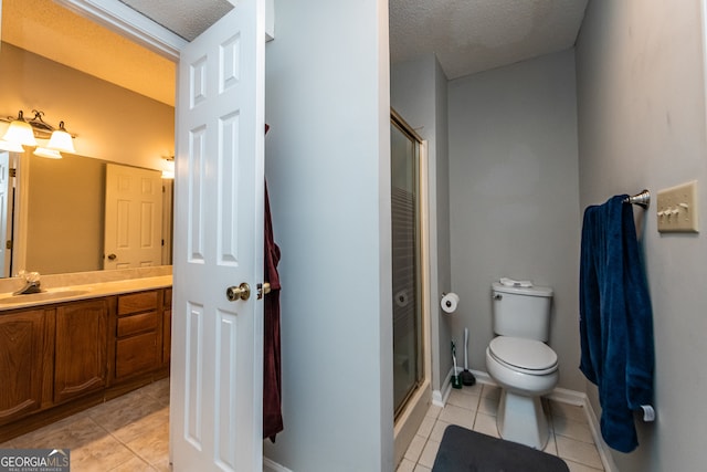 bathroom featuring tile patterned floors, vanity, and a textured ceiling