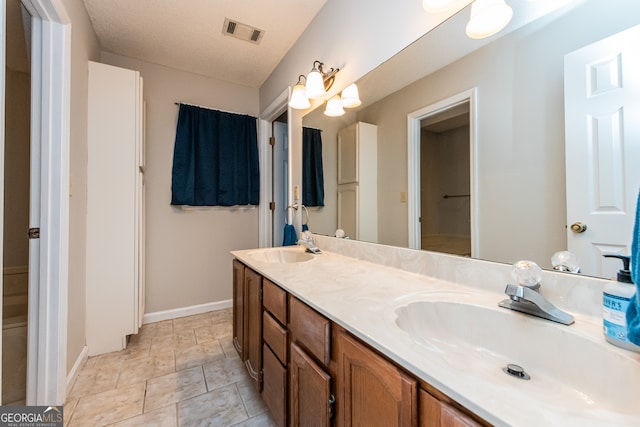 bathroom featuring vanity and a textured ceiling