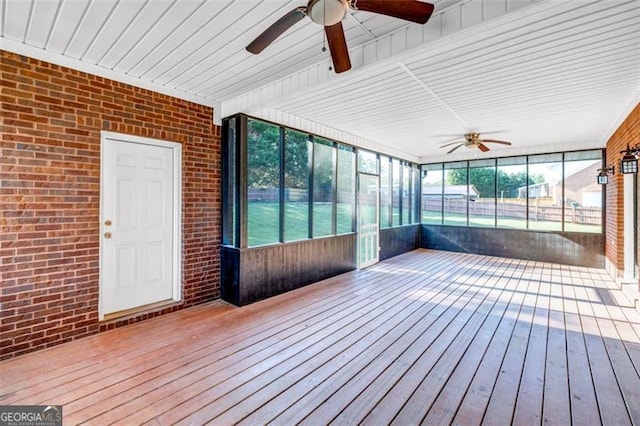 unfurnished sunroom featuring ceiling fan