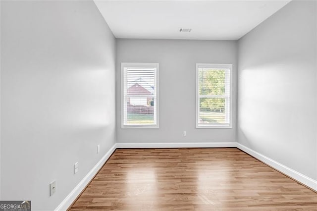 unfurnished room with light hardwood / wood-style floors