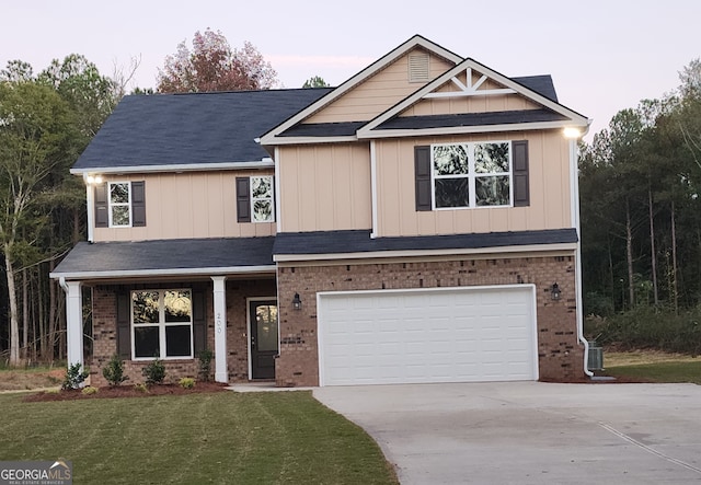 craftsman house with a front yard and a garage