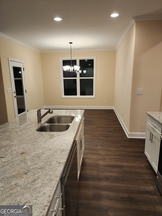 kitchen with dishwasher, decorative light fixtures, light stone counters, and sink