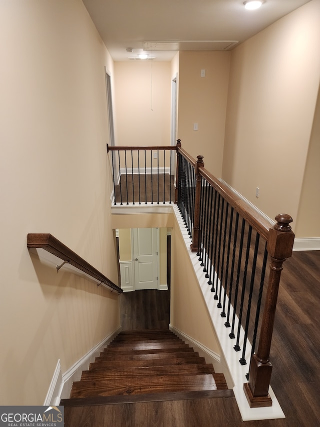 staircase with wood-type flooring