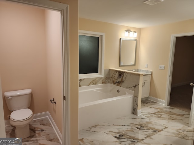 bathroom with a bathtub, vanity, and toilet