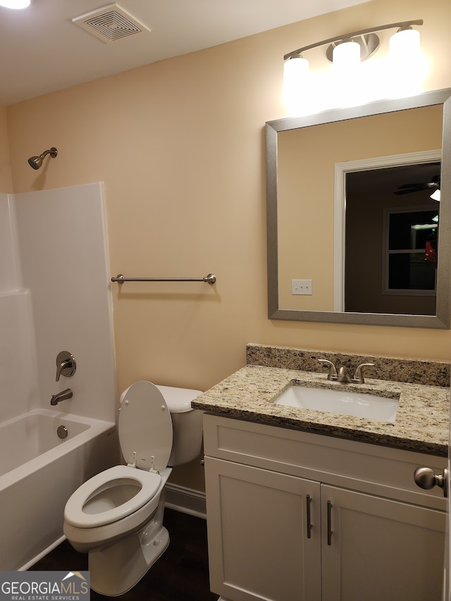 full bathroom featuring shower / bathing tub combination, vanity, and toilet