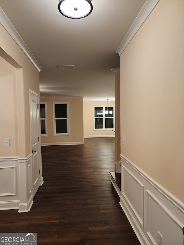 corridor with dark hardwood / wood-style flooring