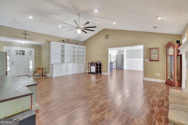 living room with lofted ceiling, hardwood / wood-style flooring, plenty of natural light, and ceiling fan