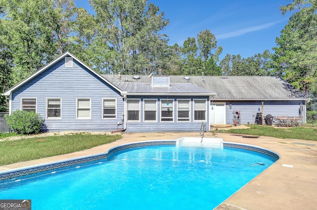 view of swimming pool with a patio, a yard, and grilling area