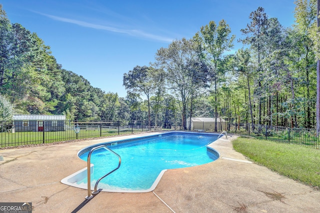 view of pool with a yard and a patio