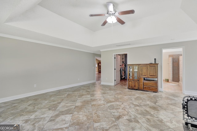 unfurnished living room featuring crown molding, ceiling fan, and a raised ceiling