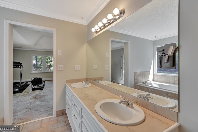 bathroom with crown molding, a bathing tub, vanity, and a textured ceiling