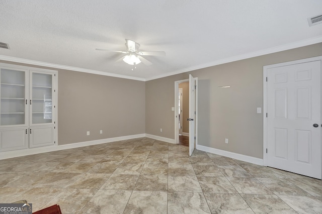 unfurnished room featuring ceiling fan, ornamental molding, and a textured ceiling