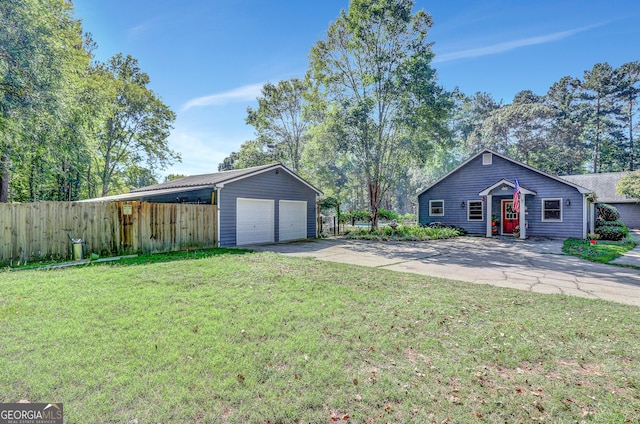 exterior space with an outbuilding, a garage, and a front lawn