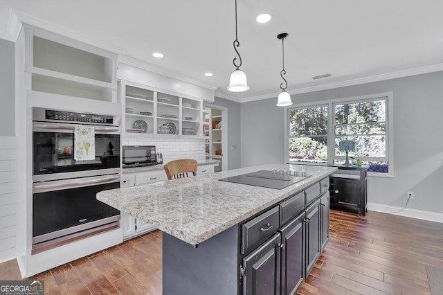 kitchen with pendant lighting, dark hardwood / wood-style flooring, double oven, a center island, and black electric cooktop