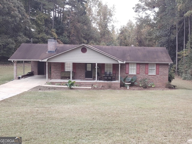 ranch-style house featuring covered porch, a front lawn, and a carport