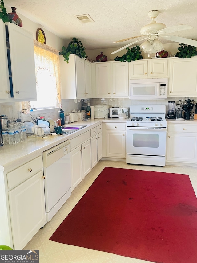 kitchen with ceiling fan, a textured ceiling, white appliances, and tasteful backsplash