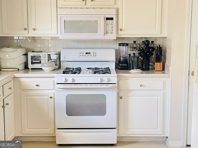 kitchen with white appliances and backsplash