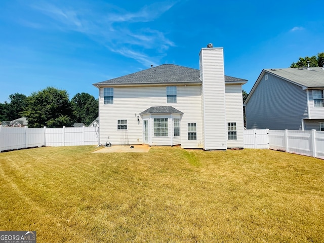 rear view of house with a lawn