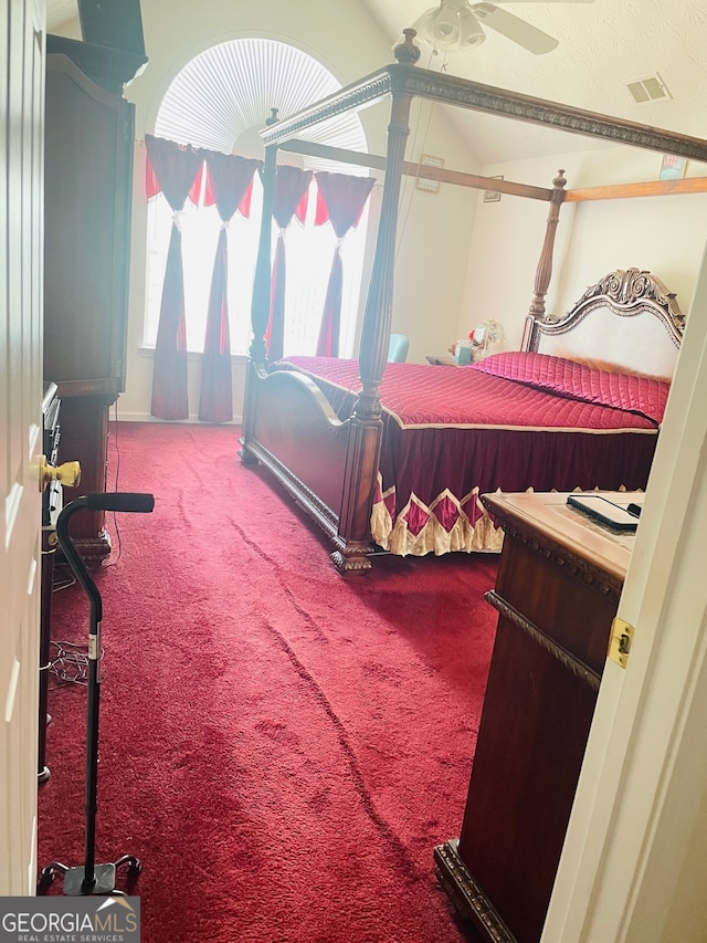 bedroom with ceiling fan, carpet floors, and vaulted ceiling with beams