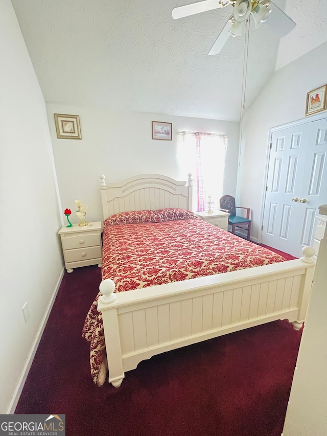 bedroom featuring a textured ceiling, vaulted ceiling, carpet flooring, and ceiling fan