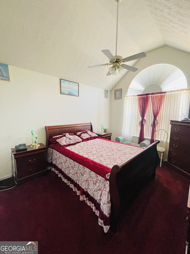 carpeted bedroom with lofted ceiling, a textured ceiling, and ceiling fan