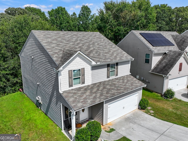 view of front of house featuring solar panels and a front lawn