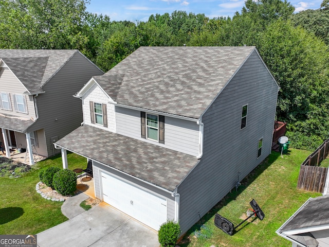 view of front of house with a front lawn and a garage