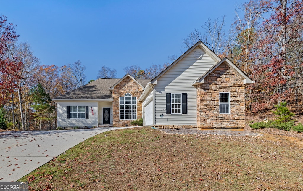 front facade featuring a garage and a front lawn