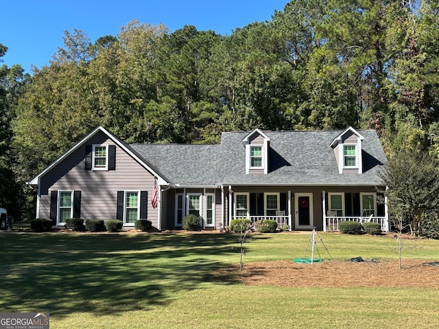 cape cod house with covered porch and a front yard