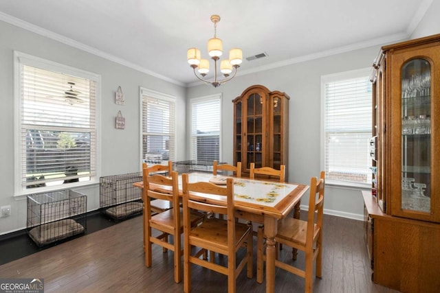 dining space with a notable chandelier, ornamental molding, plenty of natural light, and dark hardwood / wood-style flooring