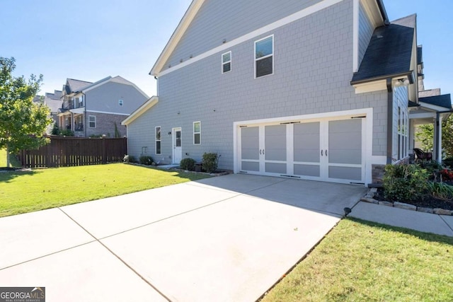 exterior space with a yard and a garage