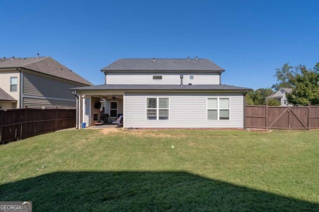 rear view of property featuring a patio and a lawn