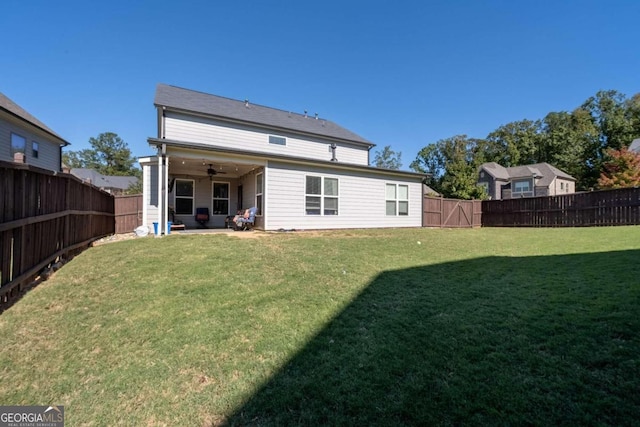 rear view of property featuring a patio, ceiling fan, and a lawn