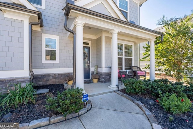 view of exterior entry with covered porch