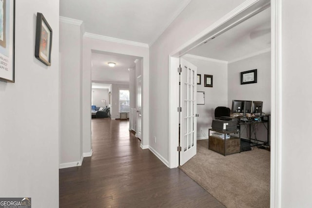 corridor featuring french doors, ornamental molding, and dark wood-type flooring