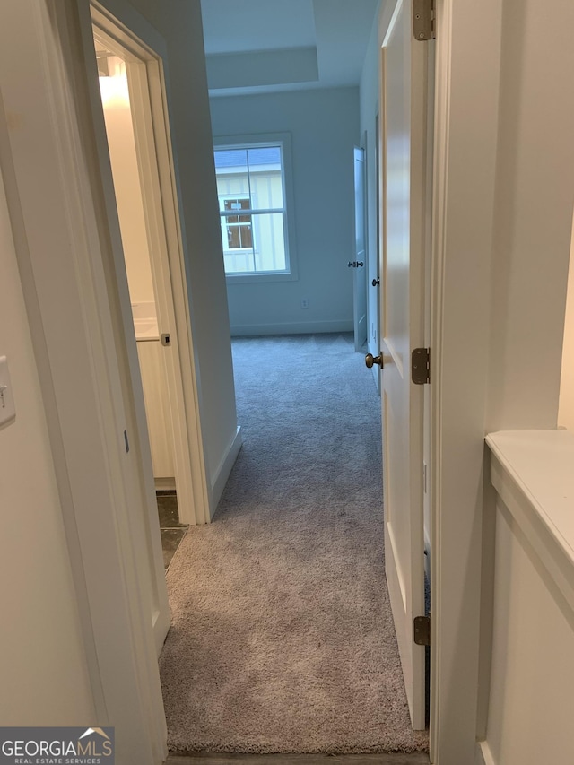 hallway with light colored carpet