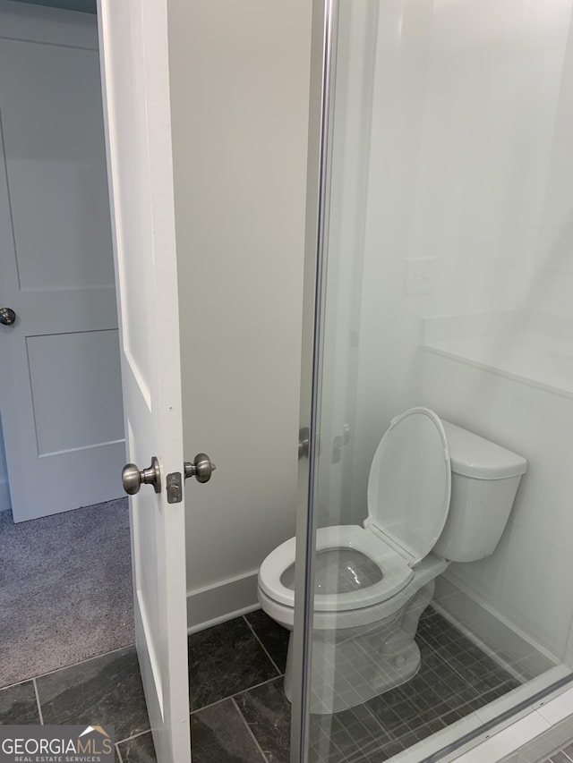 bathroom featuring toilet and tile patterned flooring