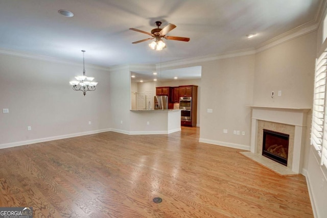 unfurnished living room featuring ornamental molding, light hardwood / wood-style flooring, and ceiling fan with notable chandelier