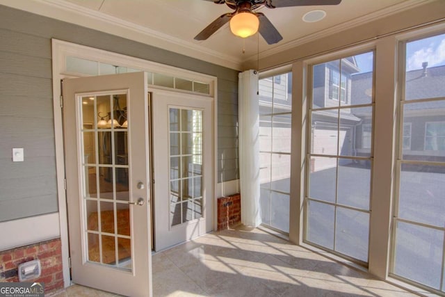 entryway with ceiling fan, ornamental molding, and plenty of natural light