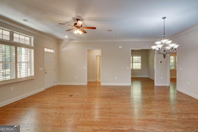 empty room with crown molding, ceiling fan with notable chandelier, and light wood-type flooring