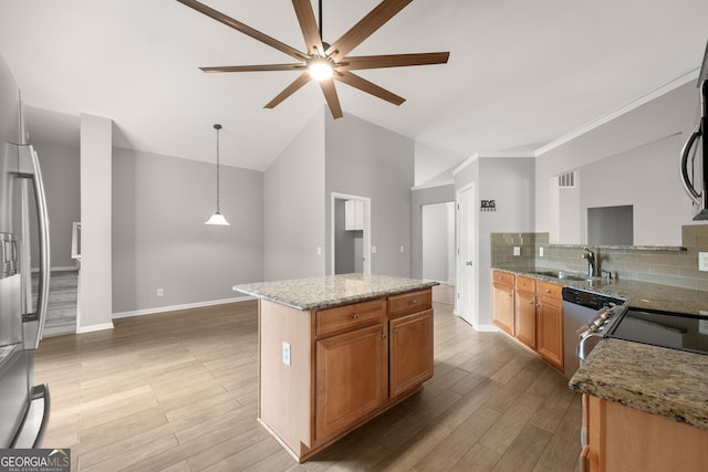 kitchen with a center island, decorative light fixtures, backsplash, and light hardwood / wood-style floors