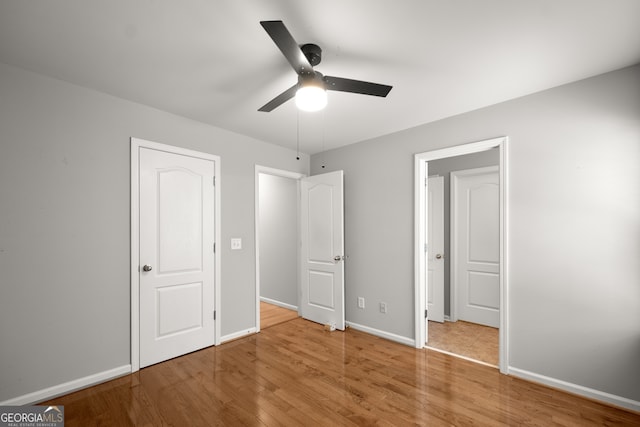 unfurnished bedroom featuring light hardwood / wood-style flooring and ceiling fan